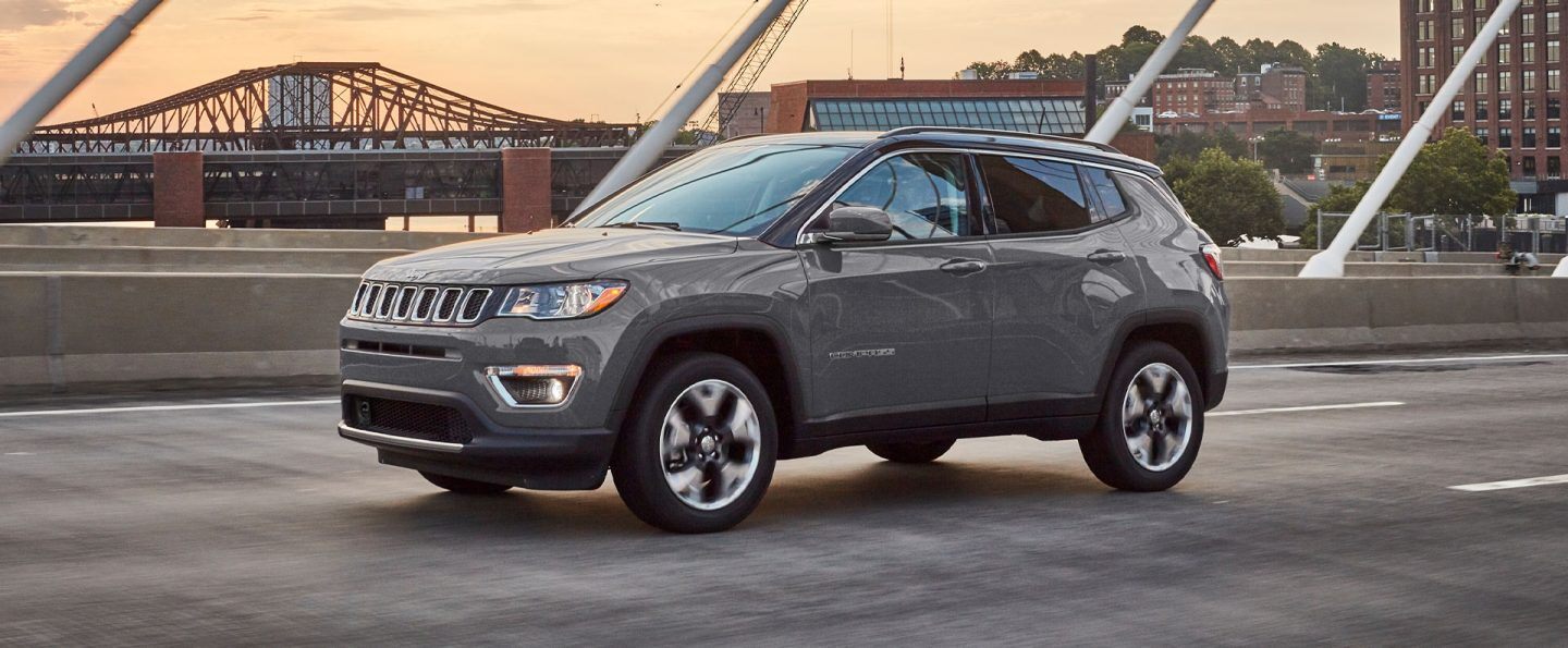 The 2021 Jeep Compass parked on an overpass.