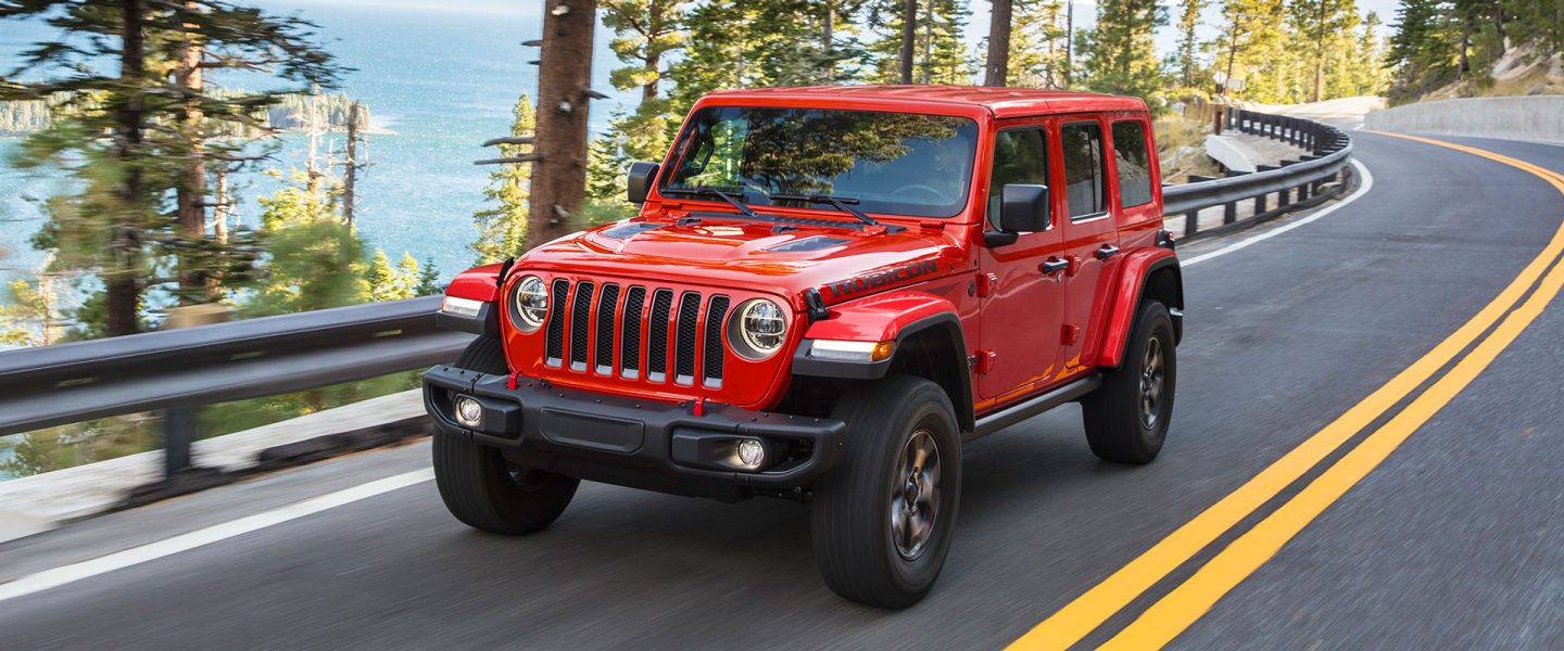 The 2021 Jeep Wrangler Rubicon being driven past a lake.